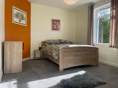 a bedroom with a bed and a window at The Wee Flat in Uphall
