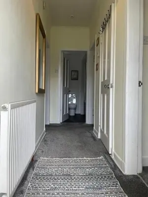 an empty hallway with a toilet in a bathroom at The Wee Flat in Uphall