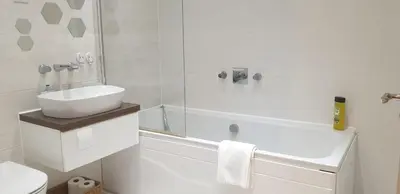 a white bathroom with a sink and a bath tub at Oatlands Oasis-FREE PARKING-2 Minutes from M74 in Glasgow