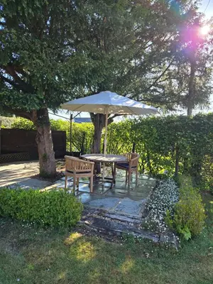 a table and two chairs under an umbrella at The Cart Barn in Moffat