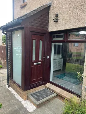 a house with a wooden door and a window at Hutchison apartments in Edinburgh