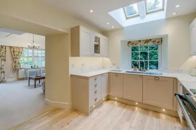 a kitchen with white cabinets and a skylight at 3 Bed in Comrie oc-e33307 in Comrie