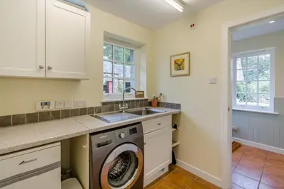 a kitchen with a washing machine and a sink at 3 Bed in Comrie oc-e33307 in Comrie
