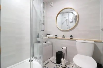 a bathroom with a toilet and a mirror at Cosy 1 bed flat in central Ayr in Ayr