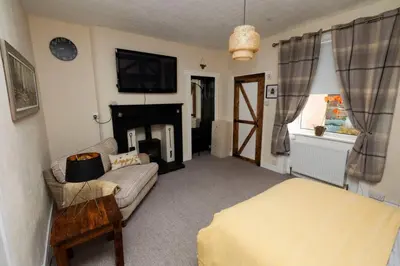 a living room with a couch and a fireplace at Troon - Coastal Getaway in Troon