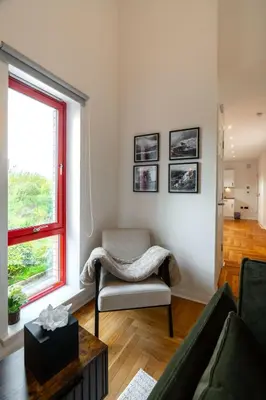 a living room with a chair and a window at Botanic House - 3BR Home - Private Parking in Glasgow