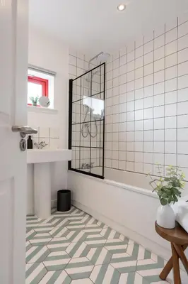 a bathroom with a white tiled floor and a mirror at Botanic House - 3BR Home - Private Parking in Glasgow