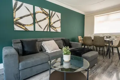 a living room with a couch and a table at 2 BDR House At Caledonia Luxe Stays Short Lets & Serviced Accommodation Hamilton in Hamilton