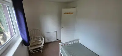 a small bedroom with a bed and a window at 3 bedrooms home away from home in Uphall