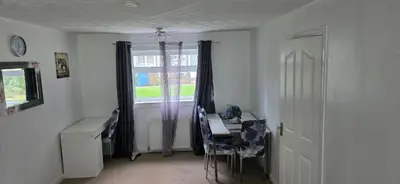 a room with a desk and a window with a table and chairs at 3 bedrooms home away from home in Uphall