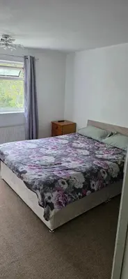 a bedroom with a bed with a purple blanket at 3 bedrooms home away from home in Uphall
