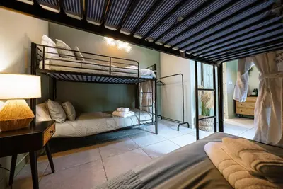 a bedroom with two bunk beds and a desk at The Cottage at Barraston Farm in Glasgow