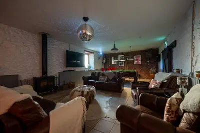 a large living room with couches and a tv at The Cottage at Barraston Farm in Glasgow