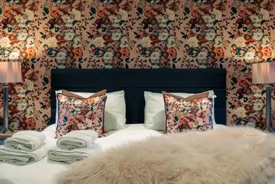a bedroom with a bed with pillows and a blanket at Barraston Farm in Glasgow