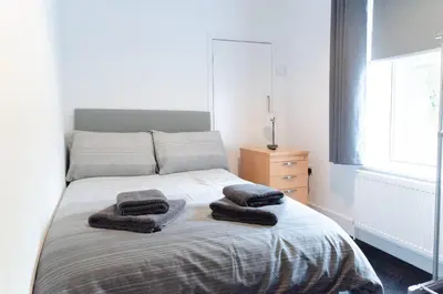 a bedroom with a bed with two towels on it at Beech Cottage in Armadale