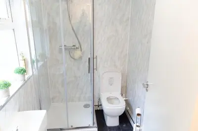 a bathroom with a toilet and a shower at Beech Cottage in Armadale