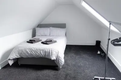 a bedroom with a bed with two towels on it at Beech Cottage in Armadale