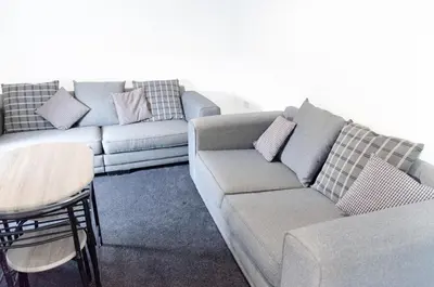 a living room with a couch and a table at Beech Cottage in Armadale