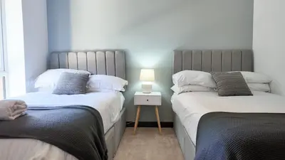 two beds sitting next to each other in a bedroom at The Sunrise Den, Modern 2-Bed Apartment, Free Parking in Yarrow