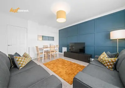 a living room with a couch and a dining room at 2 Bed Sleeps 4 with Private Parking in Airdrie in Airdrie