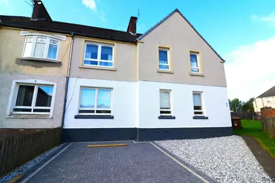 a house with a driveway in front of it at Signature - Oak House in Coatbridge