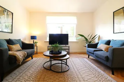 a living room with two couches and a tv at Signature - Oak House in Coatbridge