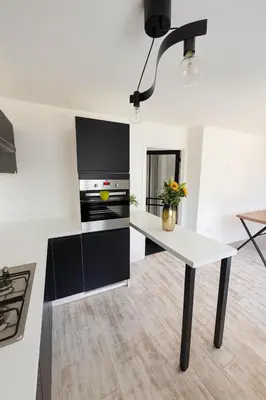 a white kitchen with a white table in a room at 3BR Detached Home, Driveway & Large Rear Garden in Hogganfield