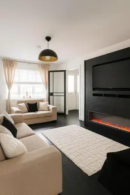 a living room with a couch and a fireplace at 3BR Detached Home, Driveway & Large Rear Garden in Hogganfield
