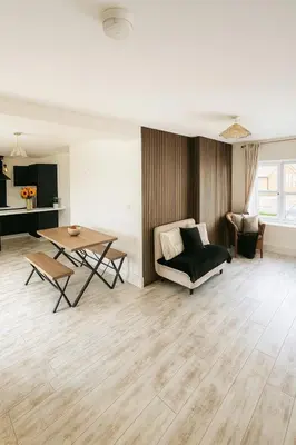 a living room with a couch and a table at 3BR Detached Home, Driveway & Large Rear Garden in Hogganfield
