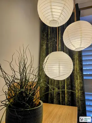 a table with three paper lanterns and a plant at High Street Stay - Oban in Oban