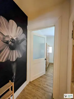 a room with a painting of a flower on the wall at High Street Stay - Oban in Oban