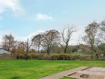 a yard with a field of green grass and trees at Arran - Uk48415 in Dalry