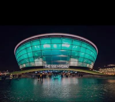 a building with the siegoks sign on it at night at City Centre Apartment in Glasgow