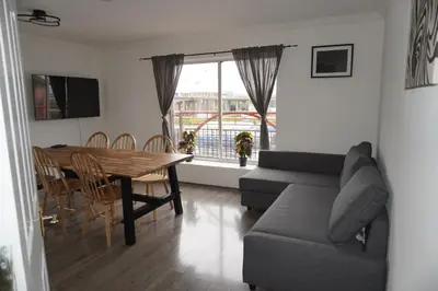 a living room with a couch and a table at Glasgow Riverview Apartment in Glasgow