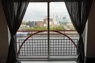 a window with a view of a city at Glasgow Riverview Apartment in Glasgow