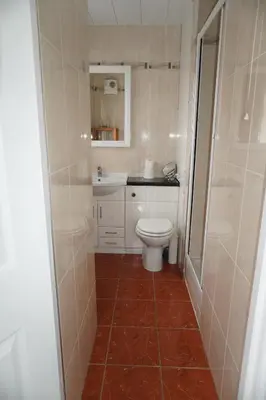 a small bathroom with a toilet and a sink at Glasgow Riverview Apartment in Glasgow
