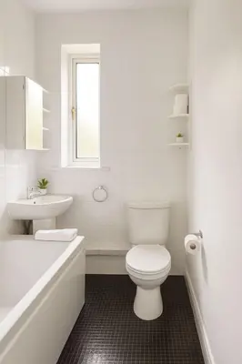 a white bathroom with a toilet and a sink at Bright & Spacious 2 Bedroom Flat in Edinburgh