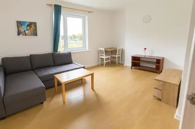 a living room with a couch and a table at Bright & Spacious 2 Bedroom Flat in Edinburgh