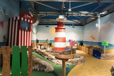 a room with a lighthouse painted on the wall at A&L Holiday Home Craigtara in Ayr