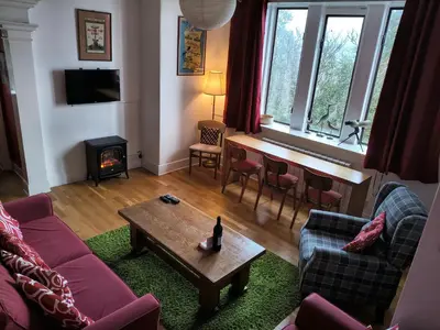 a living room with a couch and a table at A Baronial Hall apartment - great views of Loch Fyne