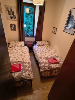 a room with two beds and a window at A Baronial Hall apartment - great views of Loch Fyne