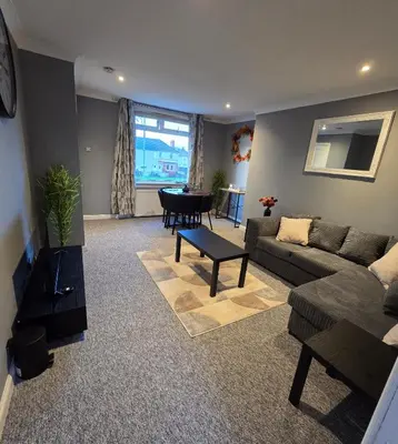 a living room with a couch and a table at 3 Bedroom FM Homes & Apartments Wishaw Motherwell in Dalziel