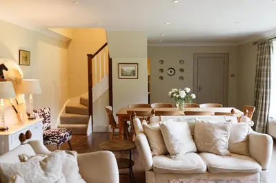 a living room with a couch and a table at The Coach House in Castle Douglas