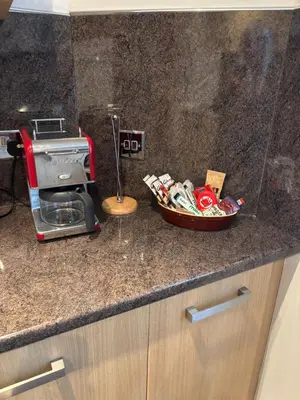 a kitchen counter with a toaster and a bowl of food at Thistle Tide 13 Nelson Street Largs KA308LN 1st Floor in Largs