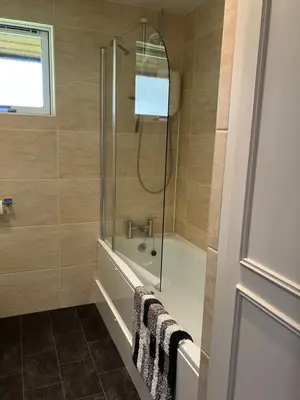 a bathroom with a shower and a bath tub at Golden Mary in Morenish