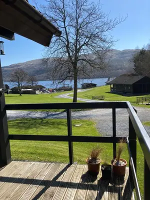 a porch with potted plants and a view of a lake at Golden Mary in Morenish