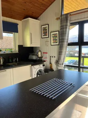 a kitchen with a black counter top and a stove at Golden Mary in Morenish