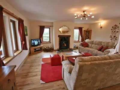 a living room with two couches and a fireplace at Laggansally Lodge in Leswalt