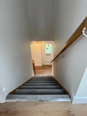 a staircase leading up to a white door at Highland Nook for 4 in Fort William
