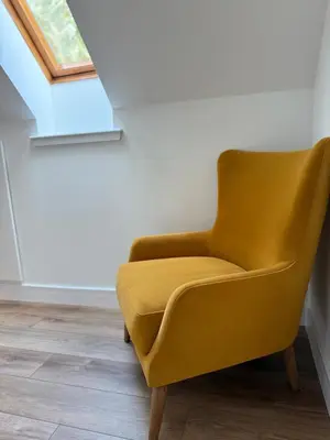 a yellow chair in a room with a window at Highland Nook for 4 in Fort William